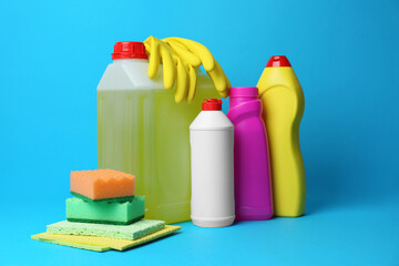 Cleaning supplies and tools on light blue background