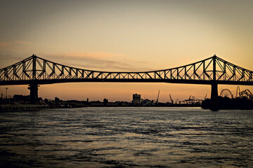 2022: Beautiful Sunrise in Old Port, clock tower and Jacques Cartier Bridge against sunset sky, Montreal, Canada