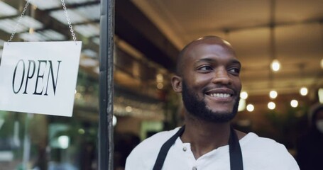 Cafe owner turning open door sign at entrance to show, greet and welcome people into local restaurant. Smiling, happy and friendly waiter opening bar and getting ready to serve or start a work shift - Powered by Adobe