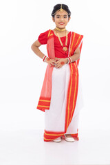 Portrait of beautiful bengali girl greeting in traditional red and white sari with jewelry
