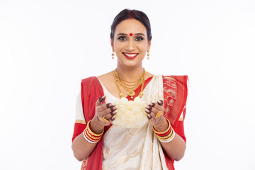 Happy woman holding bowl of fresh bengali sweet rasgulla 
