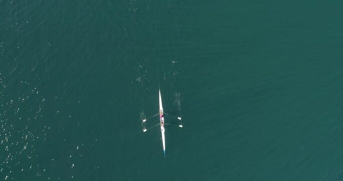 Aerial drone bird's eye view video of sport boat rowing in beautiful switzerland lavaux region