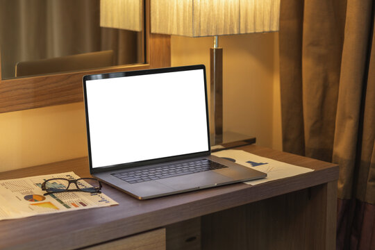 Laptop with blank screen on table in hotel room or home, mockup. Empty screen for advertise concept