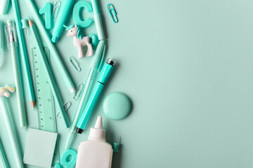 Background with various turquoise-colored stationery lying on its side