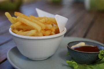 French fries with tomato sauce on the table 