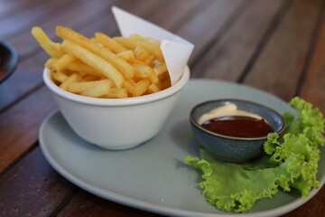 French fries with tomato sauce on the table 