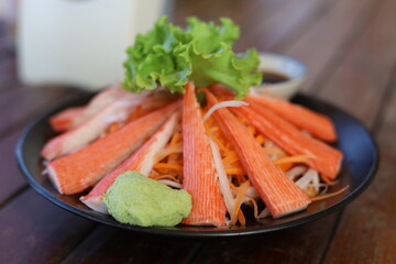 crab sticks with wasabi in black plate