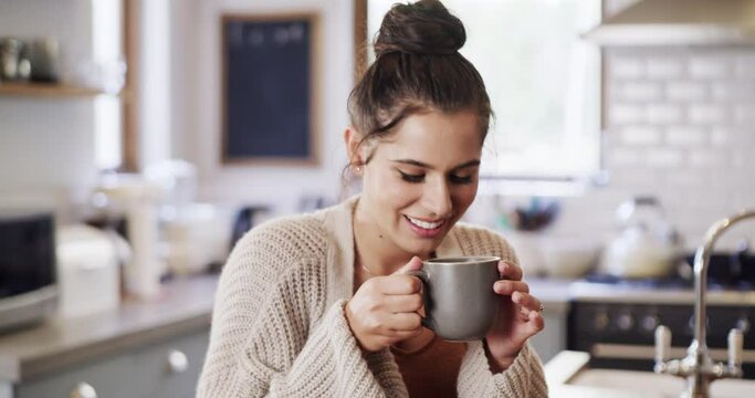 Portrait of a happy woman drinking coffee while relaxing and enjoying free time at home. Young, carefree female enjoying a tea break, feeling happy, stressless and content on the weekend indoors