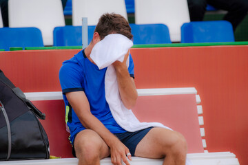 Man after training on the tennis court.
