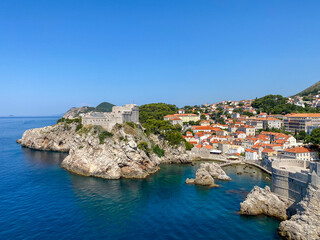 Fototapeta na wymiar Medieval architecture in the walled city and the rugged coastline of Dubrovnik, Croatia with views of the Adriatic Sea