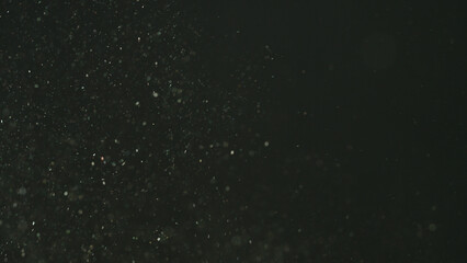 real dust particles floating over black background