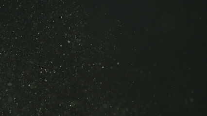 real dust particles floating over black background