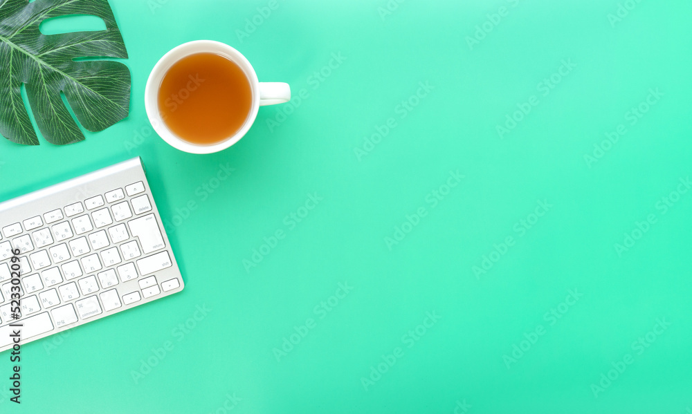 Poster Flat lay of top view desk work table with Coffee computer notebook and pencil work space in minimal green color spring tone concept includes copyspace for add text or graphic