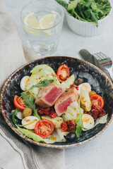 Plated salad bowl. Meat, boiled eggs, vegetables and greens mixed together