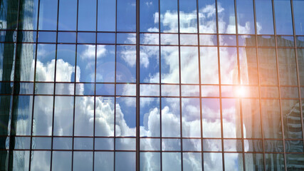 Architecture details. Modern glass building facade in sunny day. Business background.