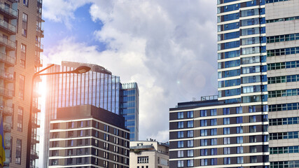 Exterior of a high modern multi-story apartment building - facade, windows and balconies.