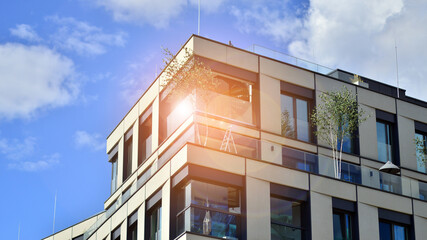 Exterior of a high modern multi-story apartment building - facade, windows and balconies.