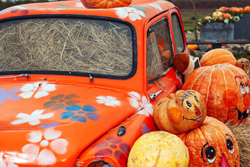 Yellow and orange pumpkins at the fair. Pumpkins in baskets and boxes. Many different pumpkins for sale. Concept of autumn, harvest and celebration.