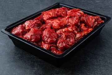 Raw pieces of meat shish kebab in marinade with pepper, onion, ready to cook, barbecue meat