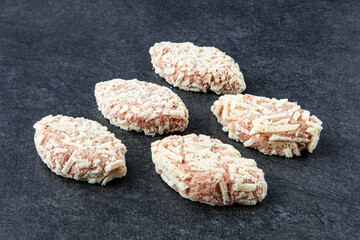 Frozen meat dumplings on gray stone background