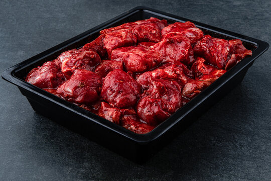 Raw pieces of meat shish kebab in marinade with pepper, onion, ready to cook, barbecue meat