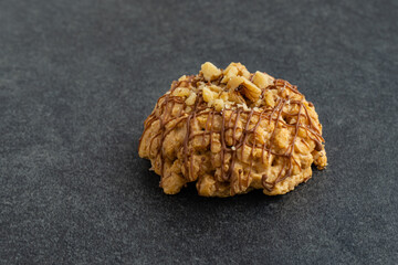 Slice of nut cake on dark background