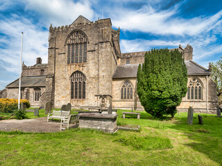 Fototapeta na wymiar 17 May 2022: Cartmel, Cumbria, UK - Cartmel Priory church, begun in 1190 and now the parish church.