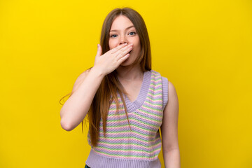 Young caucasian woman isolated on yellow background happy and smiling covering mouth with hand