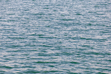 Blue turquoise transparent water surface of a sea with small waves