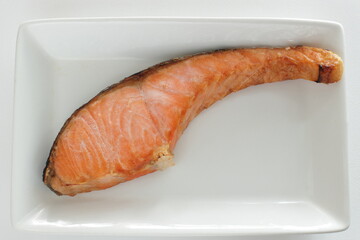 Japanese food, grilled salted salmon fish f on dish with copy space