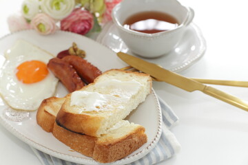sausage and sunny side up fried egg served with cream cheese toast 