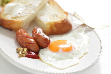 sausage and sunny side up fried egg served with cream cheese toast 