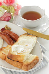 sausage and sunny side up fried egg served with cream cheese toast 