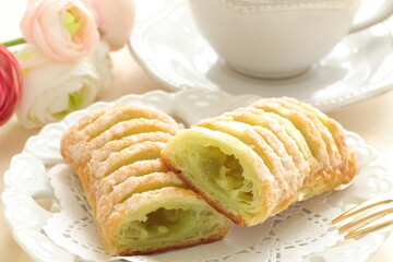 Green tea cream pie on dish with English tea