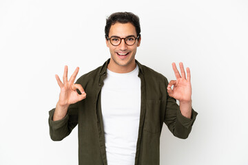 Caucasian handsome man over isolated white background showing ok sign with two hands