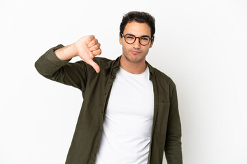 Caucasian handsome man over isolated white background showing thumb down with negative expression