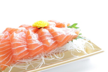 Japanese raw fish,  salmon slices on shaved radish in take out food tray with copy space