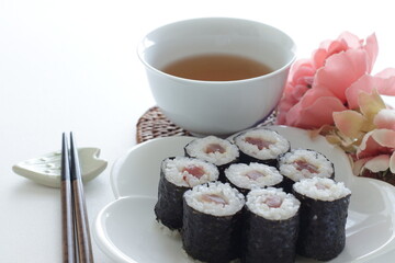 Japanese food, tuna fish roll sushi on dish with tea