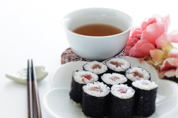 Japanese food, tuna fish roll sushi on dish with tea
