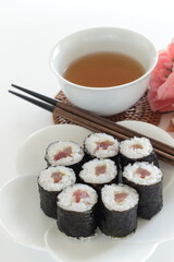 Japanese food, tuna fish roll sushi on dish with tea