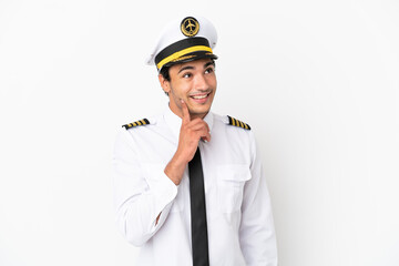 Airplane pilot over isolated white background thinking an idea while looking up