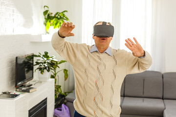 Portrait of mature man testing virtual reality headset