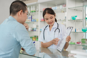 Medicine and health concept, Pharmacist explain prescription and side effect of medicine to client