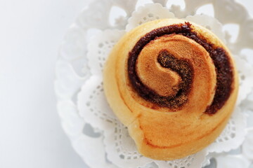 Cinnamon bun on white dish for breakfast image