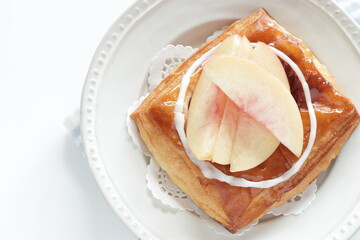 Homemade peaches Danish pastry on dish with copy space