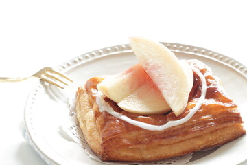 Homemade peaches Danish pastry on dish with copy space