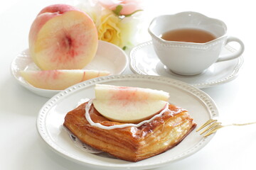 Homemade peaches Danish pastry on dish with copy space