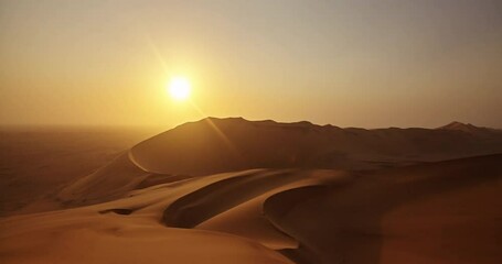 Beautiful empty sand dunes during sunset in the desert on a late summer afternoon. Time lapse of the landscape of a big dry hill at dawn or nightfall outdoors in breathtaking nature