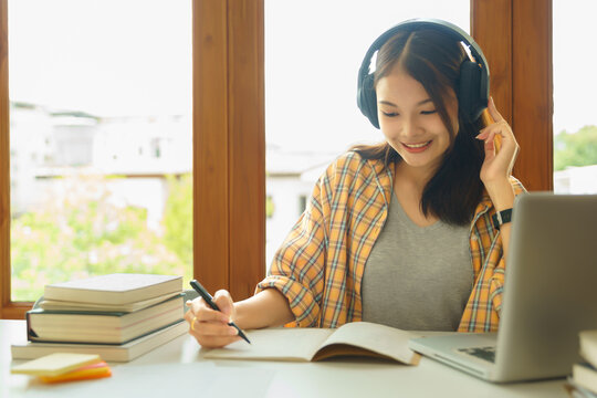 Education And Literacy Concept, College Student Girl Listening Lecture Online And Doing Test