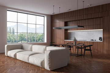 Light wooden kitchen interior with couch and dining area, panoramic window